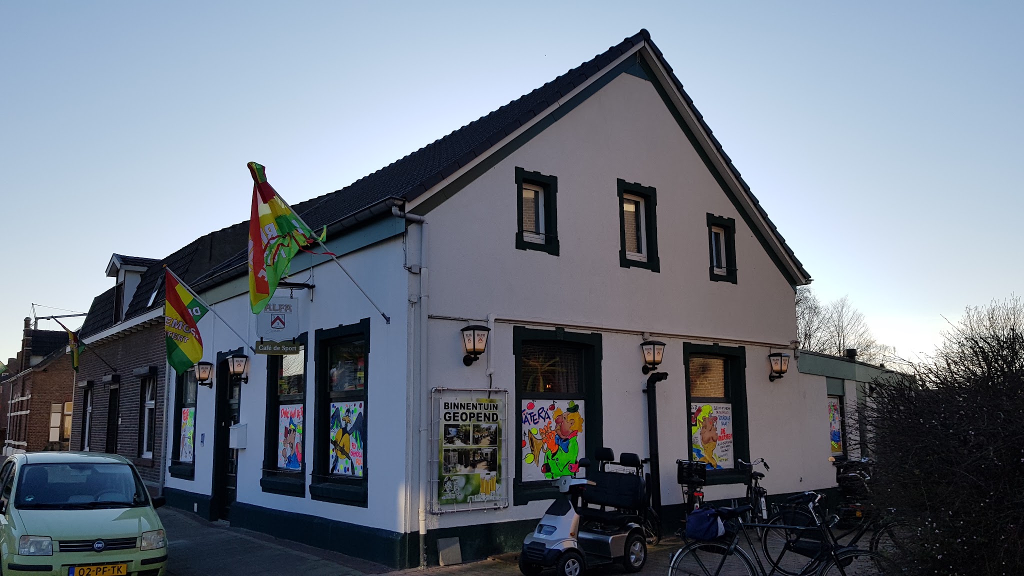 De gevel van Café de Sport aan de Hoofdstraat, met de vlaggen uit